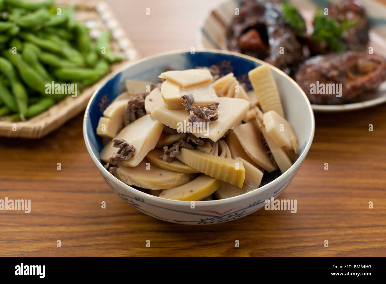 Takenoko - Japanese bamboo shoots - cooked with slivers of meat and served in a typically Japanese bowl Stock Photo