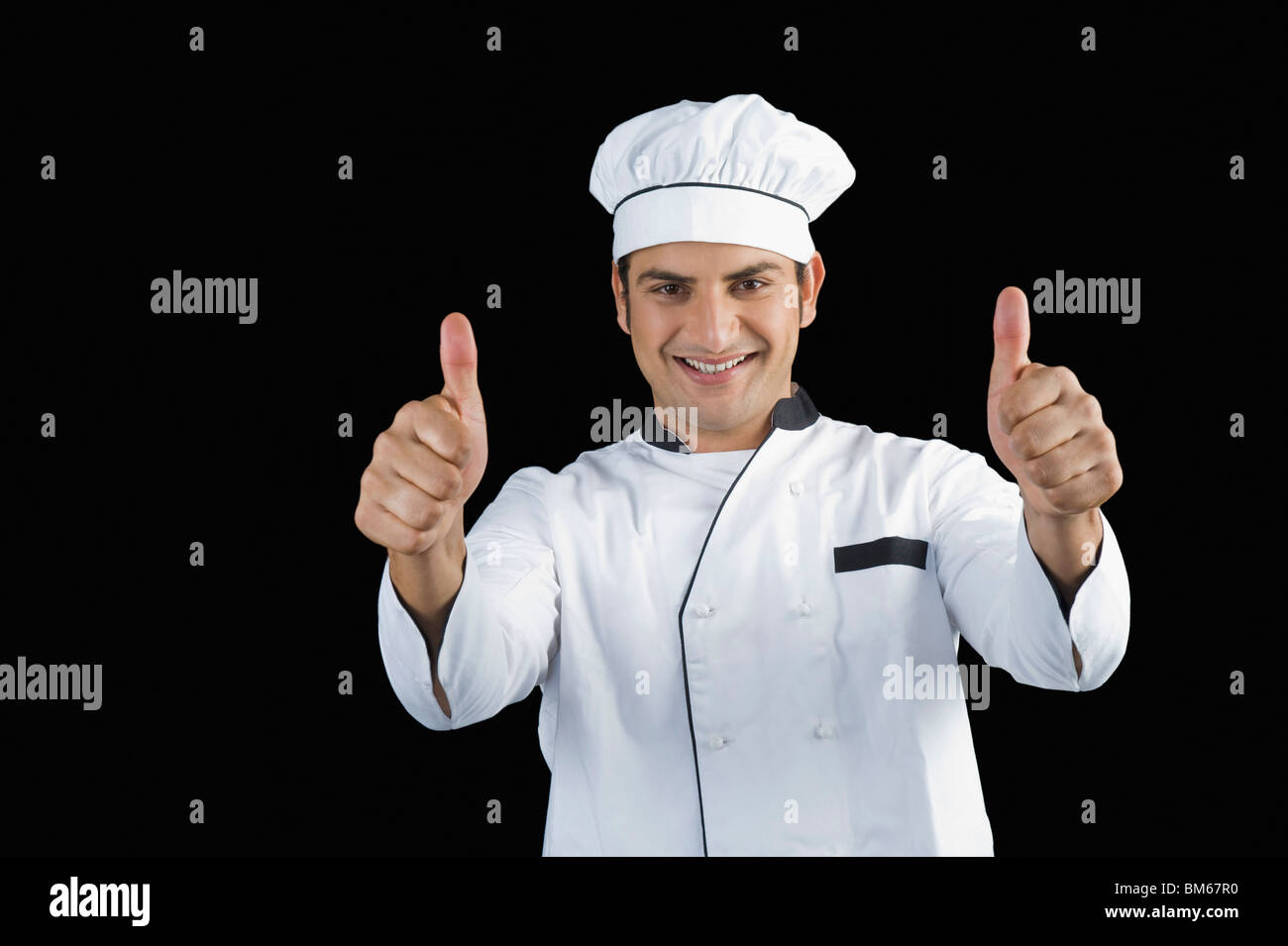 Portrait of a chef gesturing thumbs up sign Stock Photo
