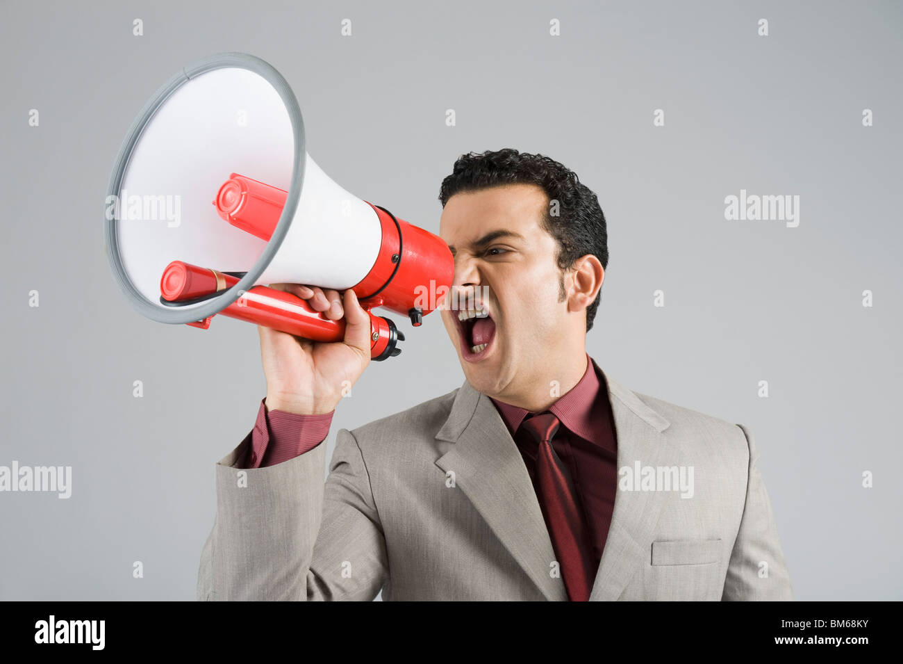 Businessman shouting into a megaphone Stock Photo Alamy