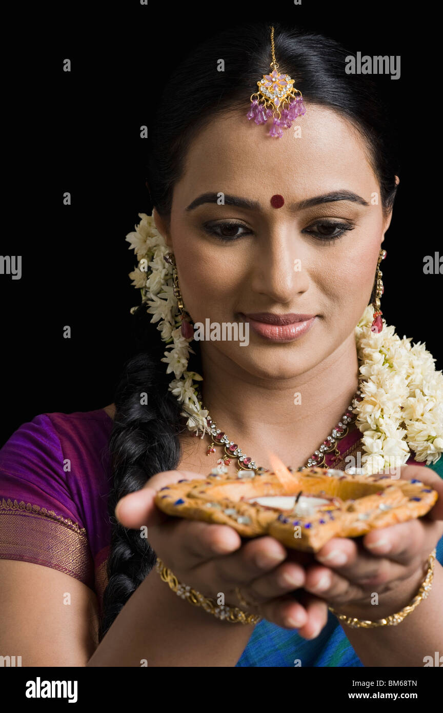 Woman praying with an oil lamp Stock Photo Alamy