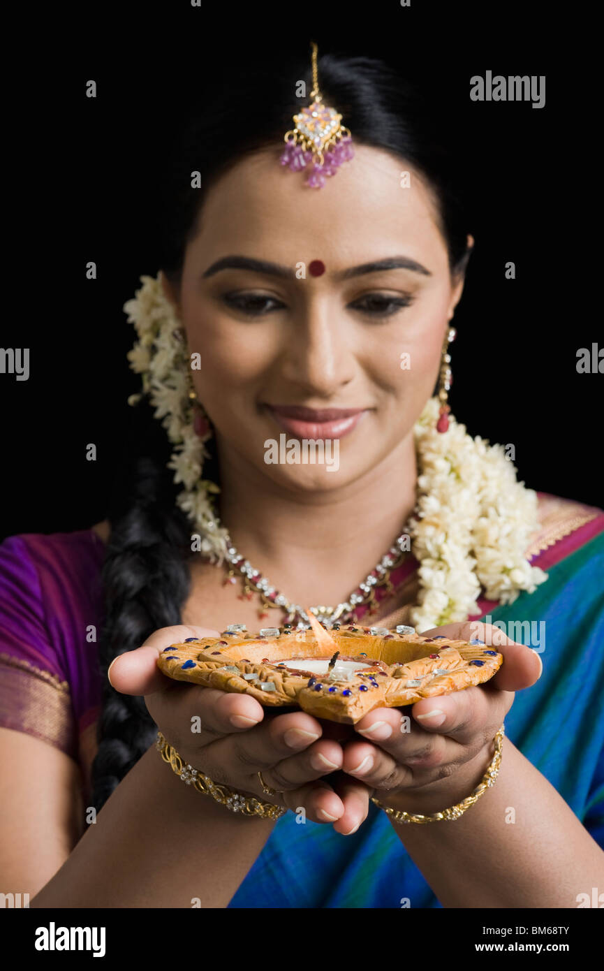 Woman praying with an oil lamp Stock Photo Alamy
