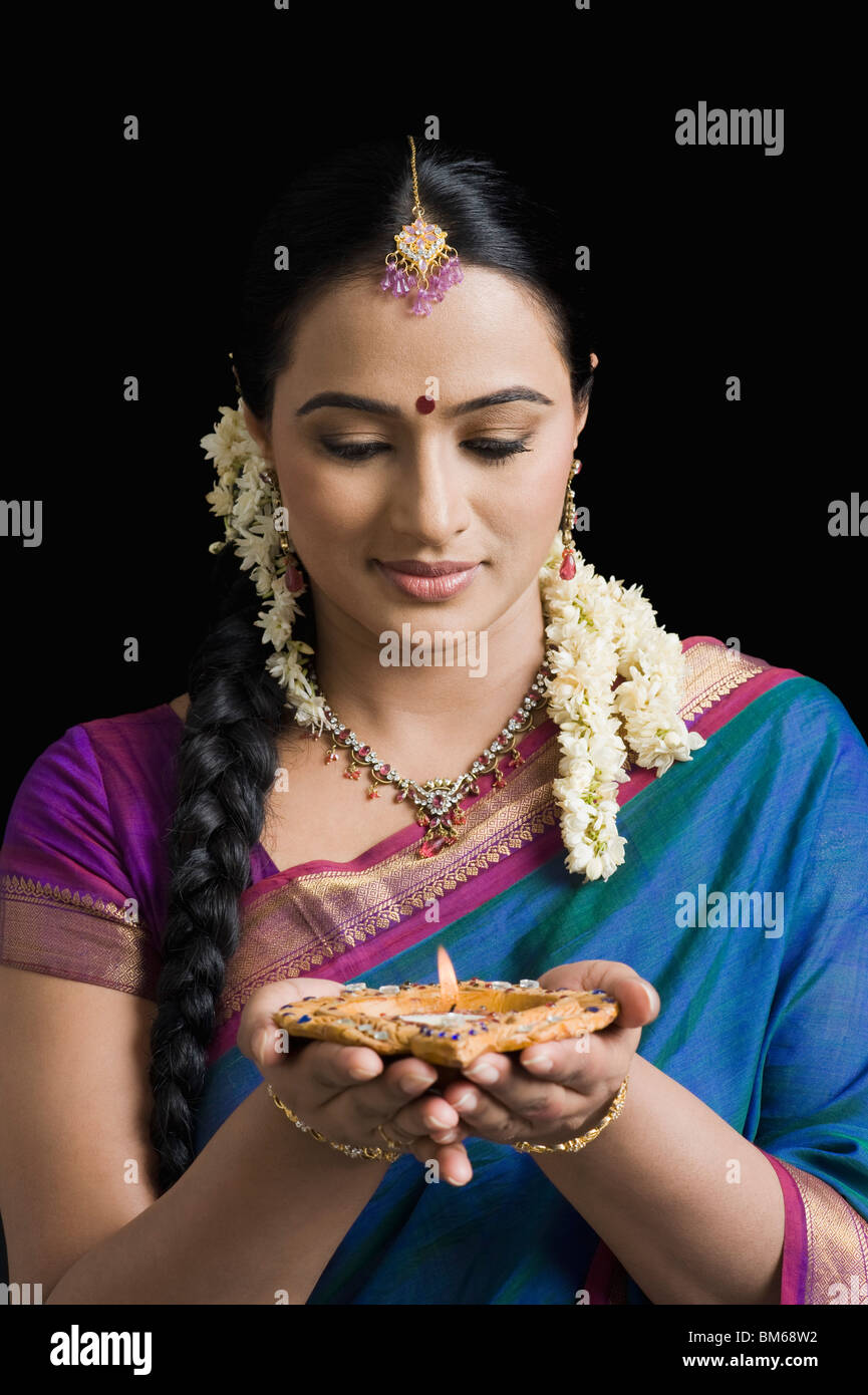 Woman praying with an oil lamp Stock Photo Alamy