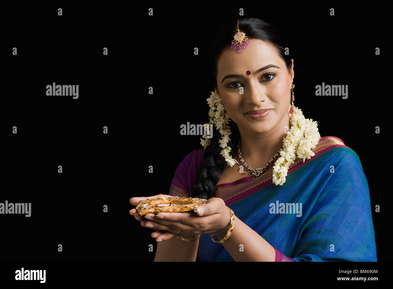 Woman praying with an oil lamp Stock Photo Alamy