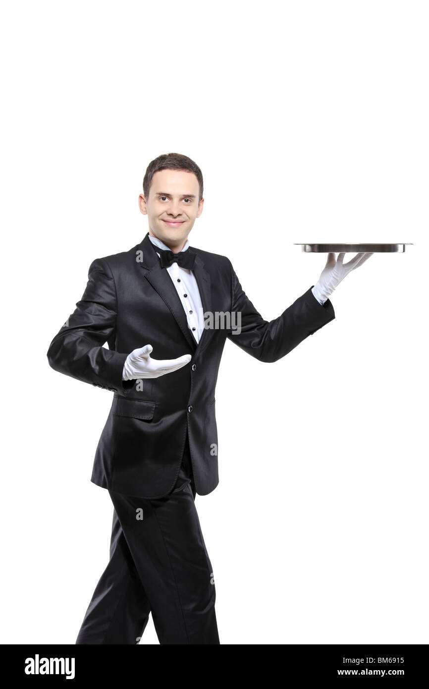 A young butler carrying a tray Stock Photo