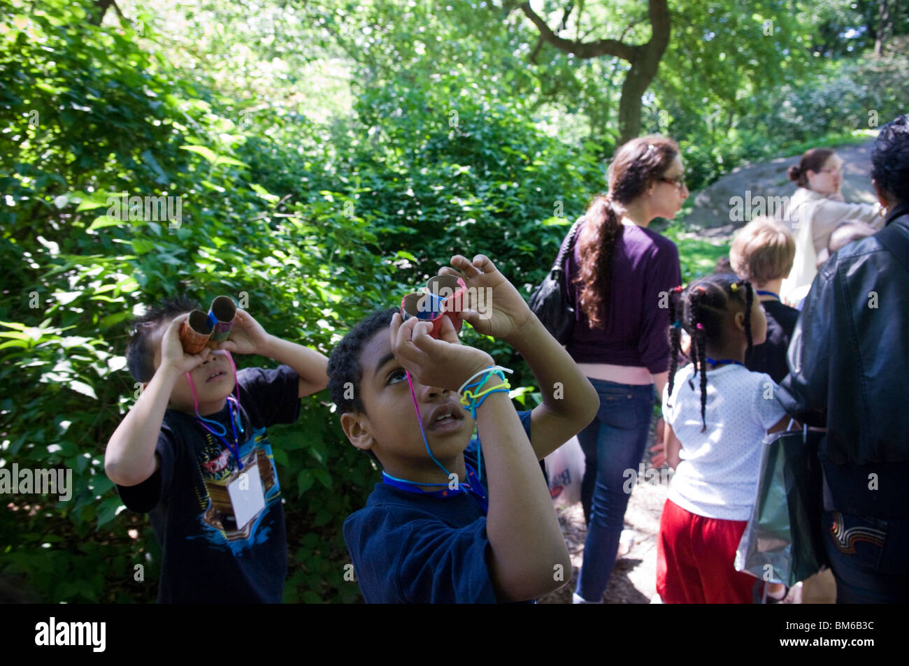 First grade students go birding in Central Park in New York with homemade binoculars Stock Photo
