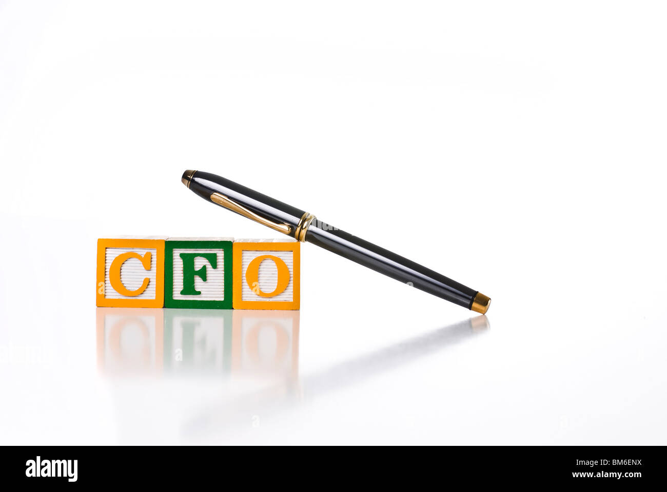 Colorful children's blocks spelling CFO with executive style pen Stock Photo