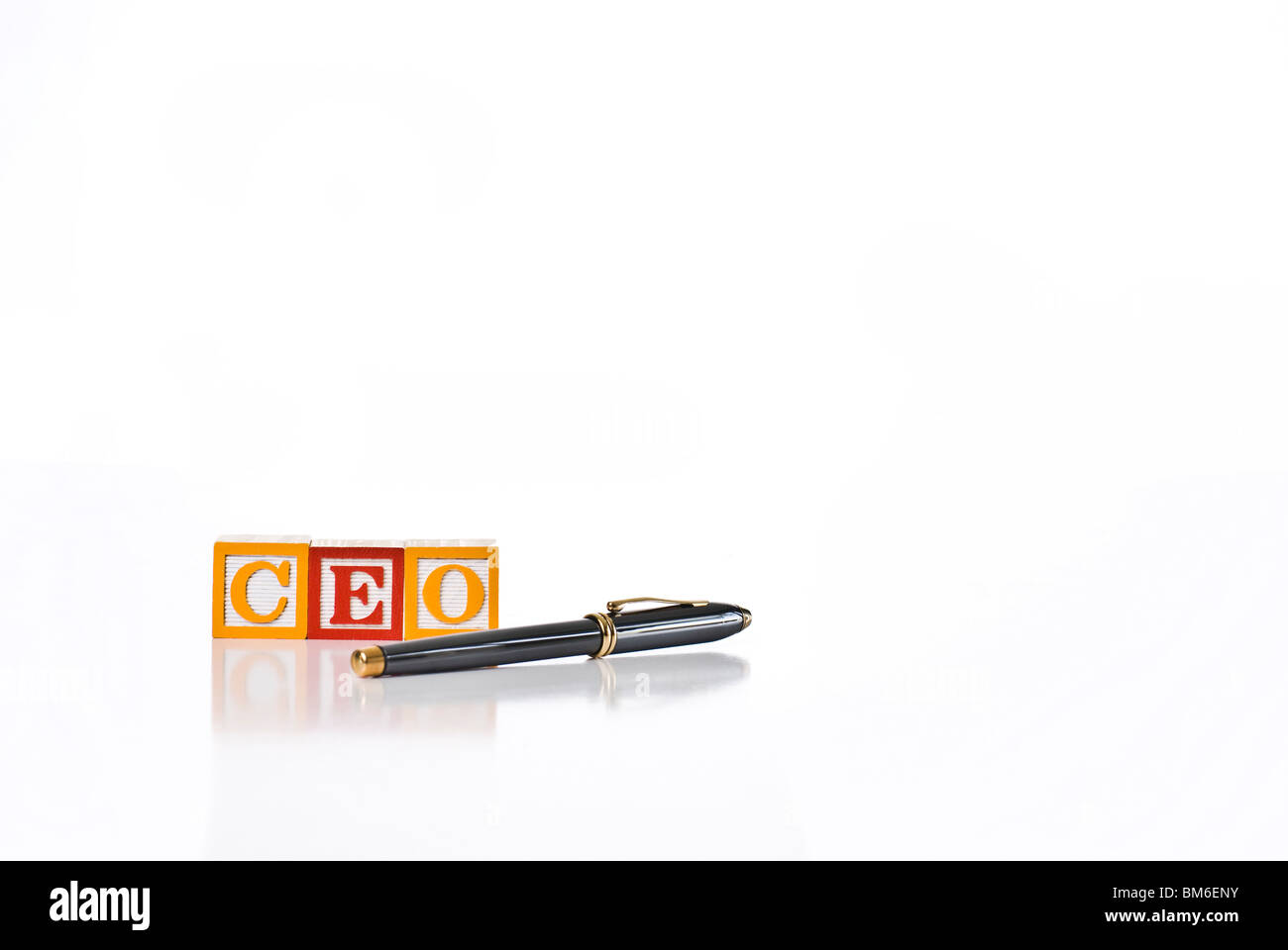 Colorful children's blocks spelling CEO with executive style pen Stock Photo