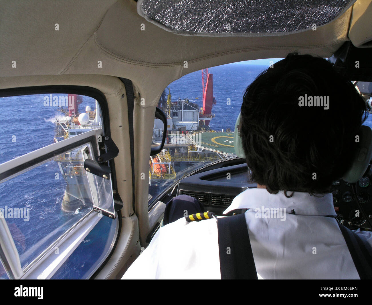Helicopter landing at petroleum platform, Bacia de Campos, Brazil. View from inside helicopter. Stock Photo
