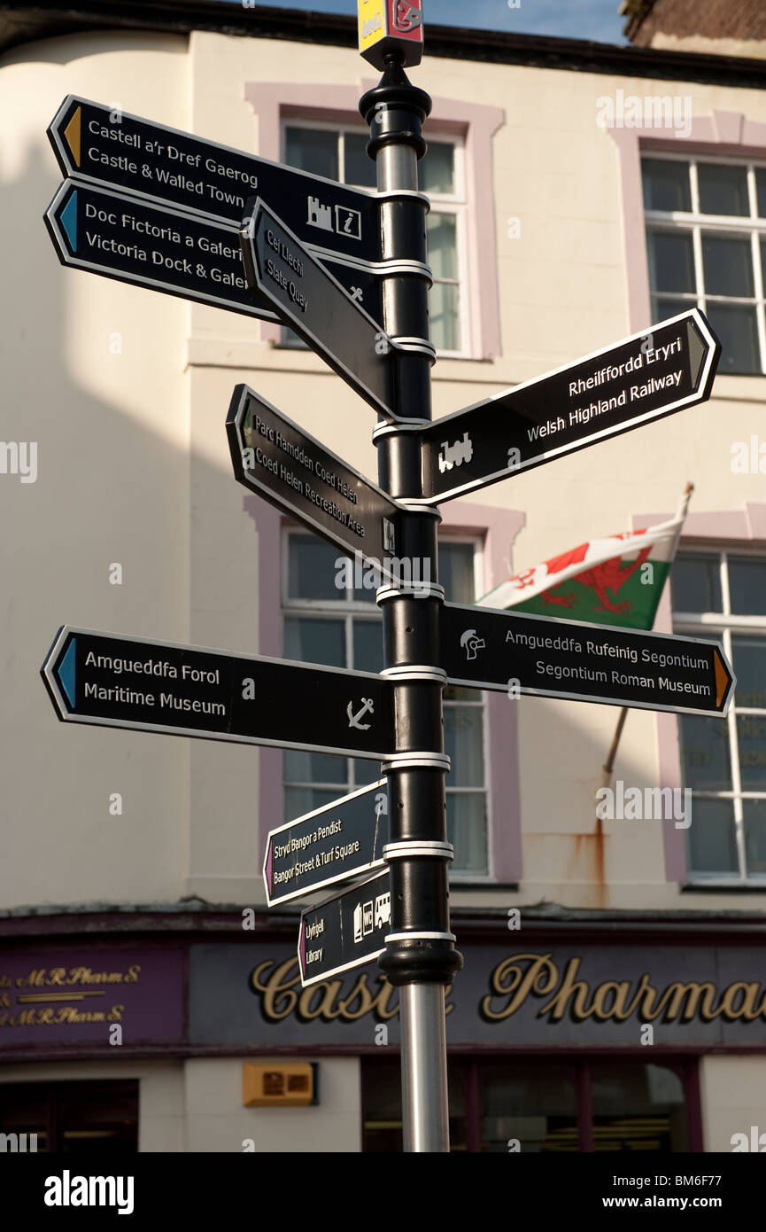 Tourist information signs pointing to various attractions in Caernarfon town, North Wales UK Stock Photo