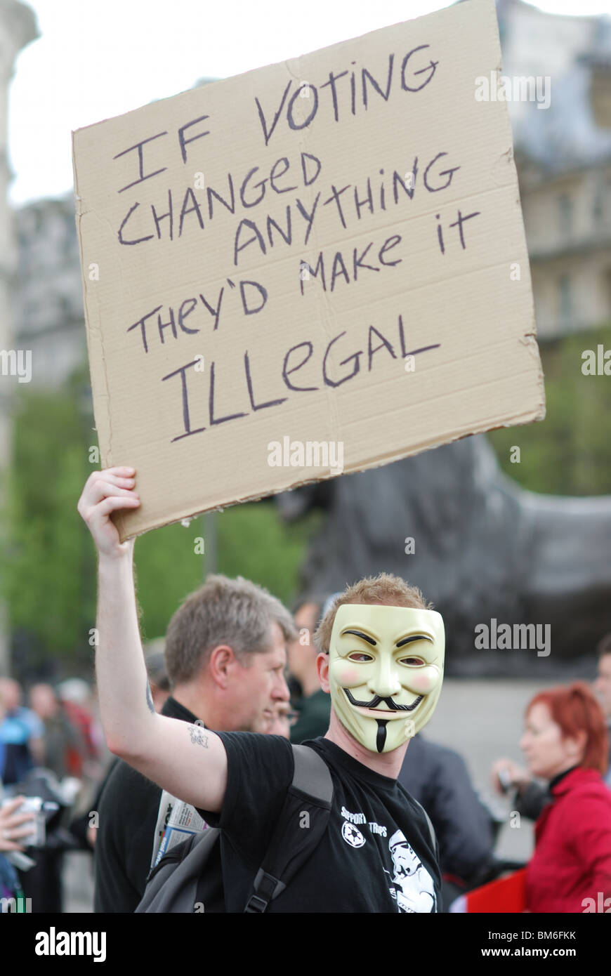 A demonstrator on May Day holds a placard saying, 'If voting changed anything they'd make it illegal.' Stock Photo