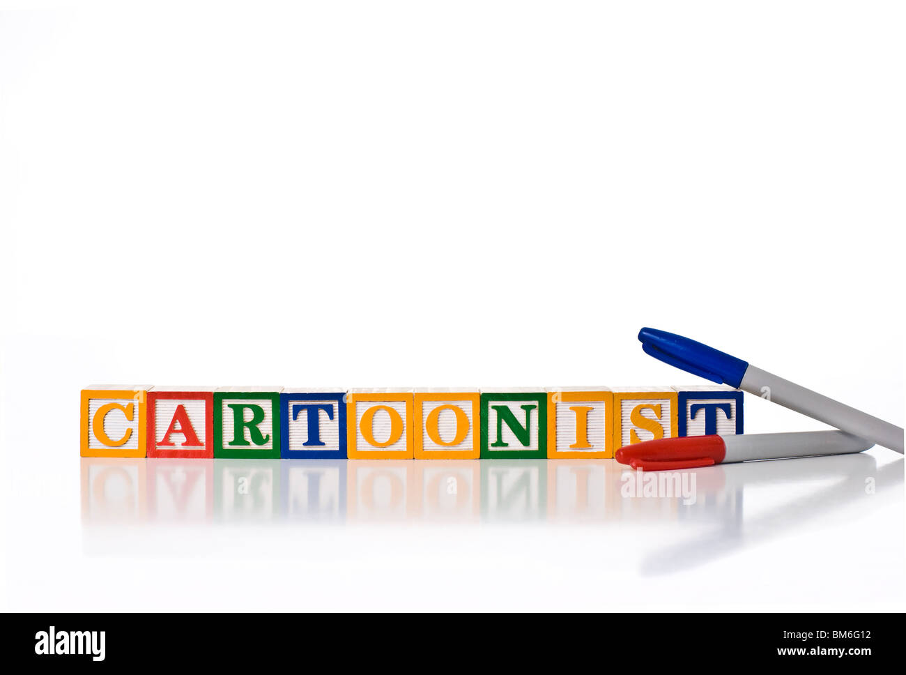Colorful children's blocks spelling the word CARTOONIST with colored felt-tipped pens Stock Photo