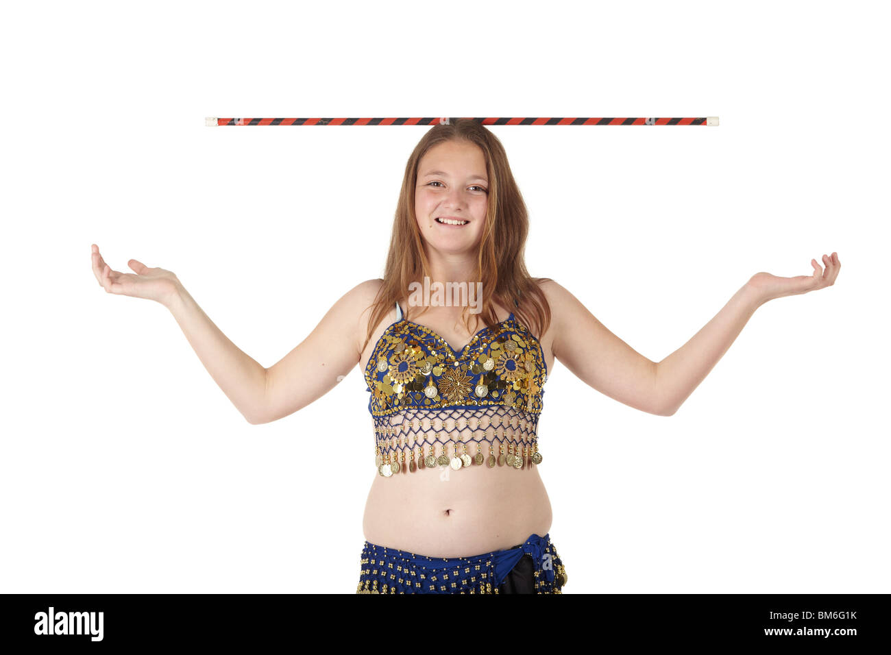 Young Caucasian belly dancing girl in beautiful decorated clothes on white background and reflective floor. Not isolated Stock Photo