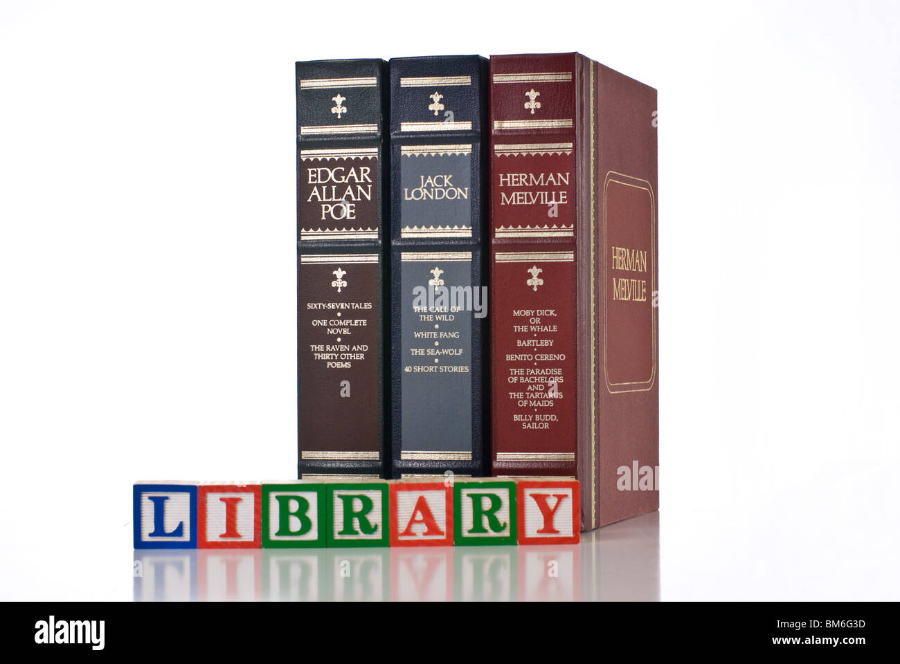 LIBRARY spelled using colorful children's wooden blocks with books behind Stock Photo
