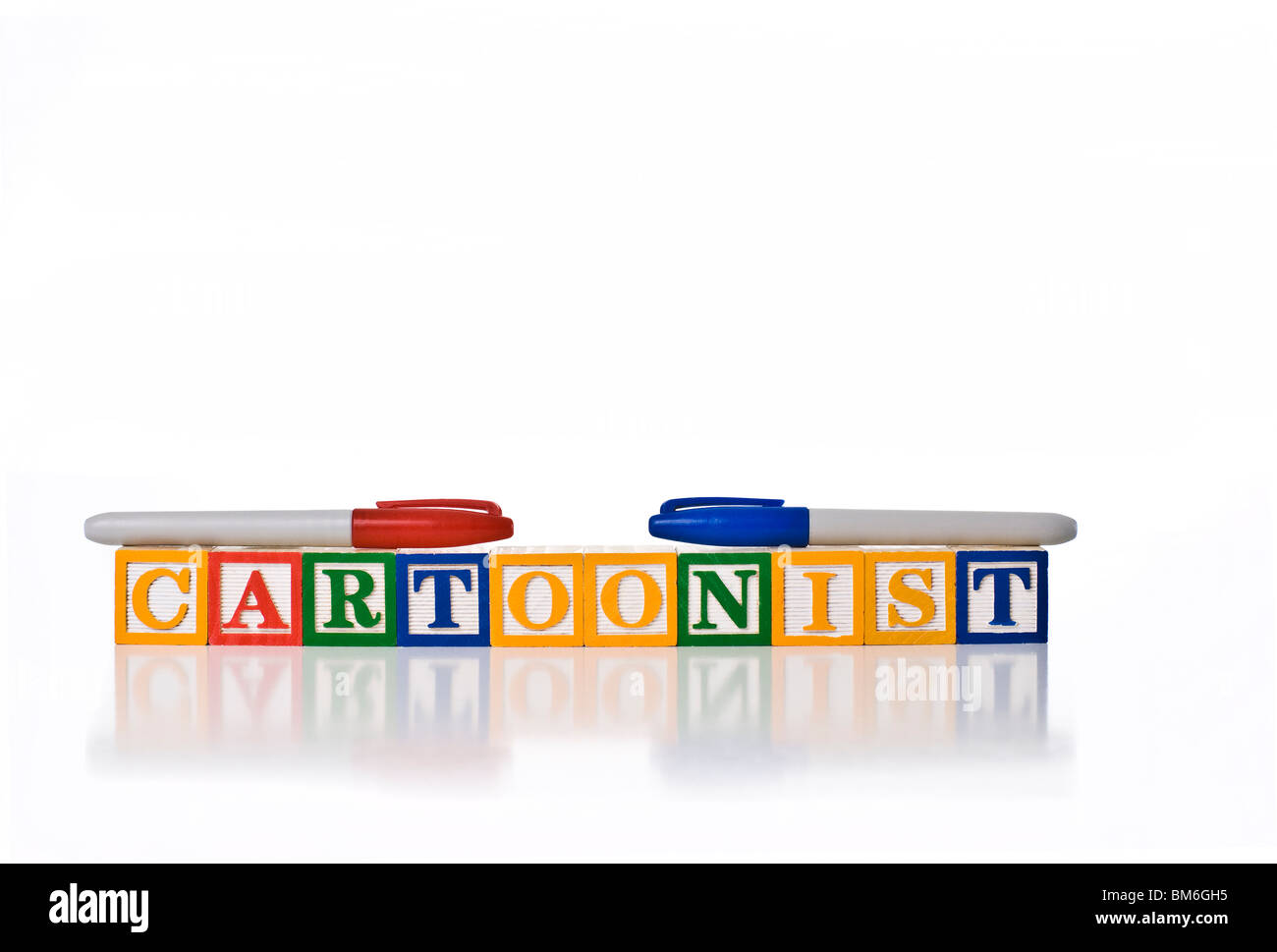 Colorful children's blocks spelling the word CARTOONIST with colored felt-tipped pens Stock Photo