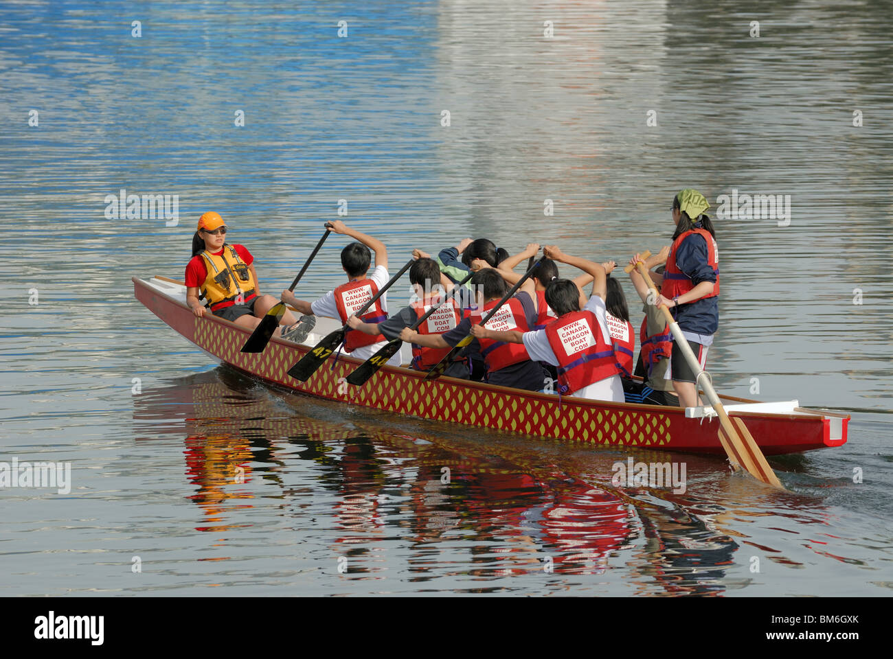 Ten person Dragon Boat with full crew training for the annual Dragon Boat Festival in False Creek, City of Vancouver Stock Photo