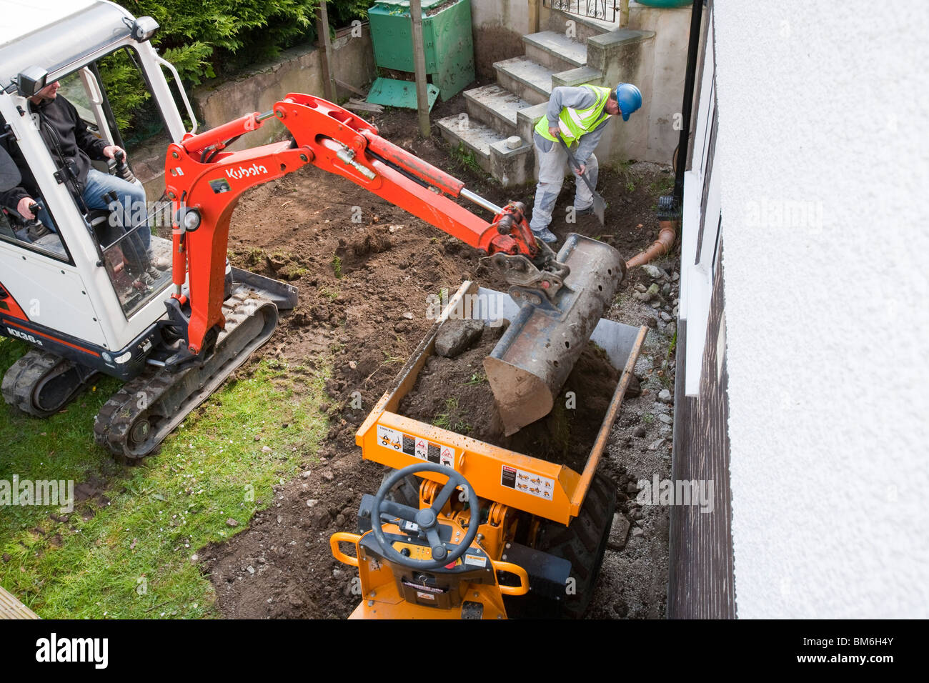 A mine digger and mini dumper truck on a house extension, building job, Ambleside, Cumbria, UK. Stock Photo