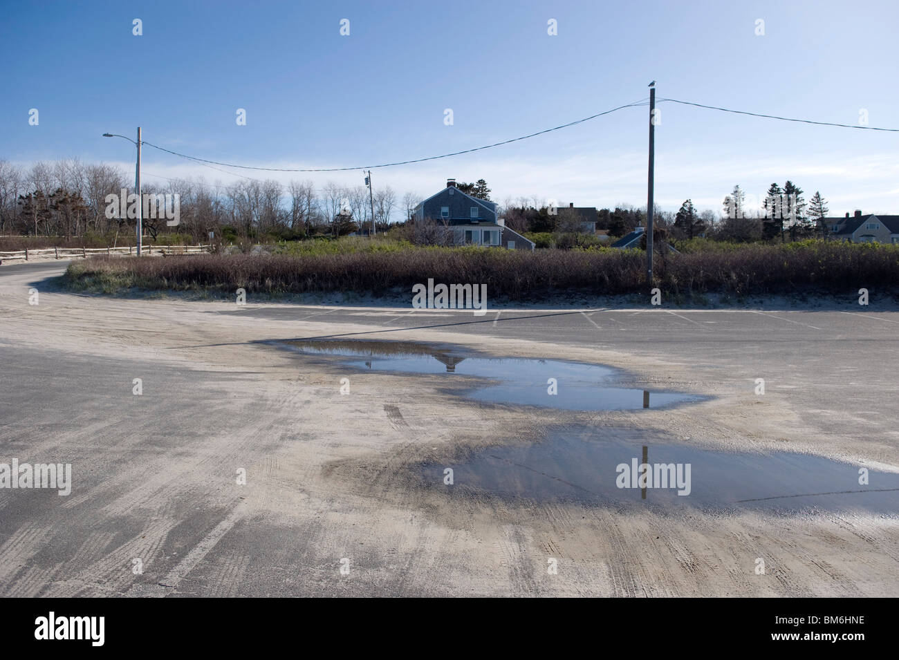 Puddles in a parking lot at Corporation Beach in Dennis, Cape Cod Stock  Photo - Alamy