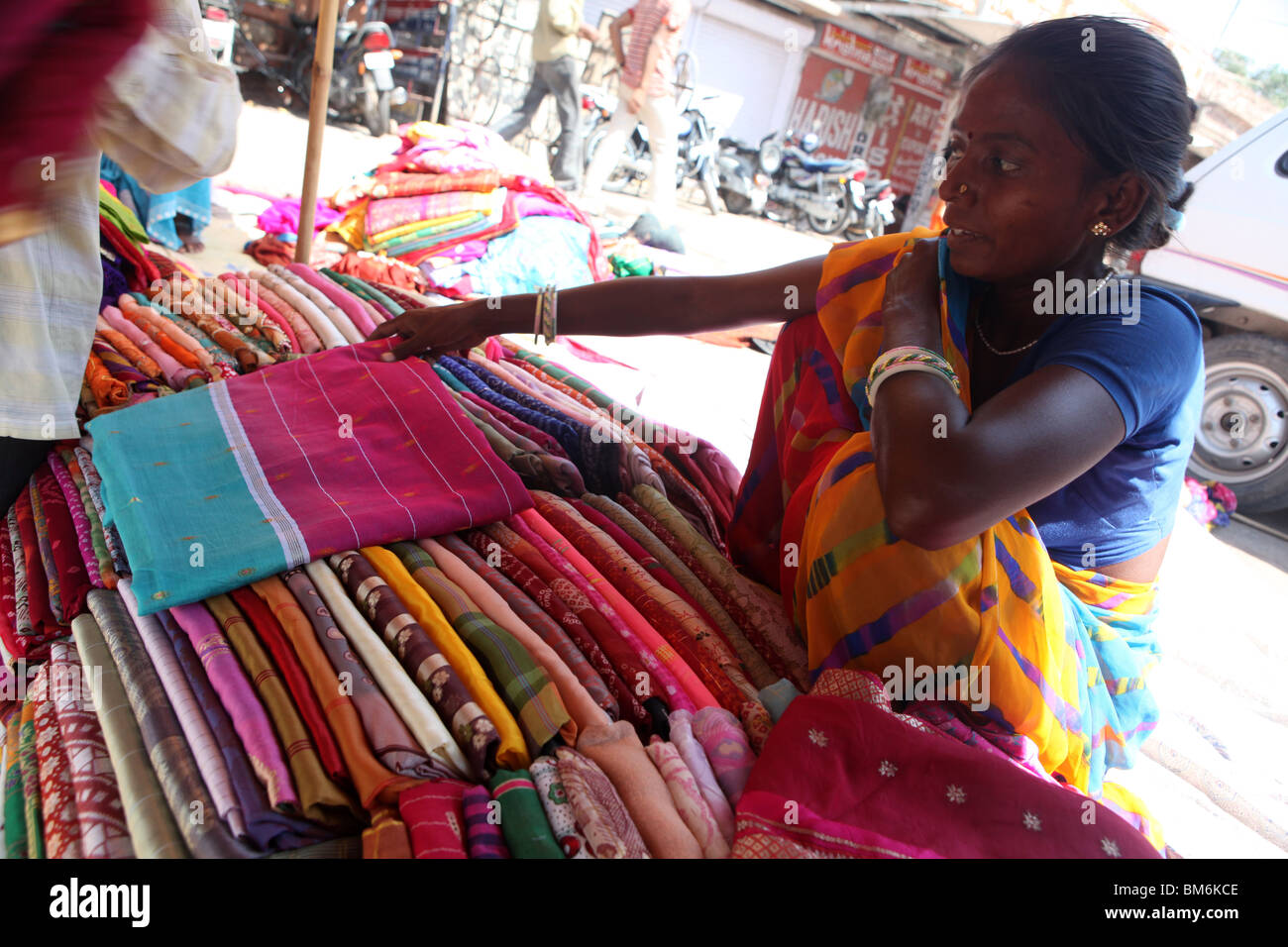 An indian lady selling saris at the Sardar Market Jodhpur ,Rajasthan, India. Stock Photo