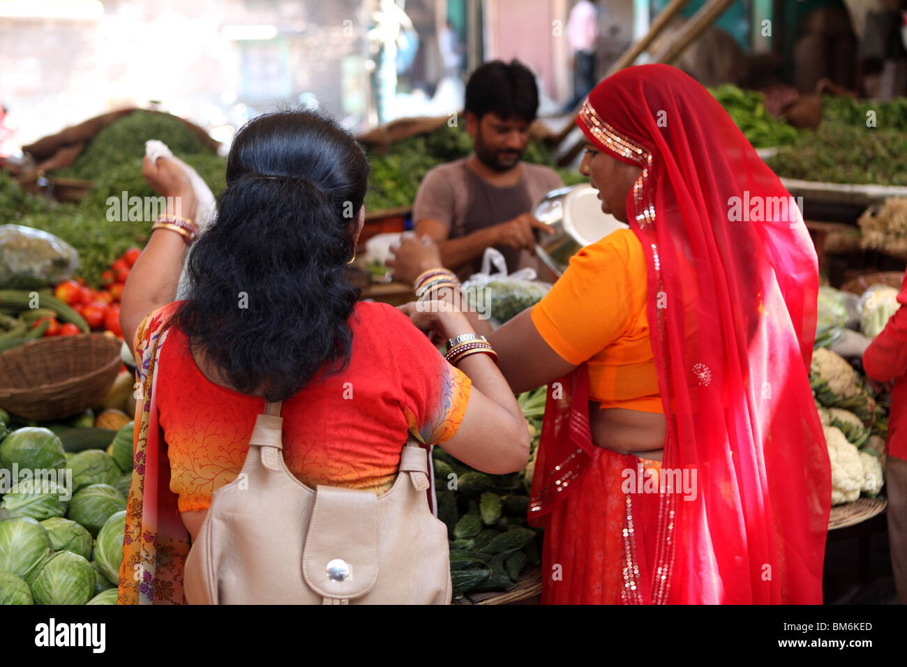 Indian women buying vegetables at the Sardar Market Jodhpur ,Rajasthan, India. Stock Photo