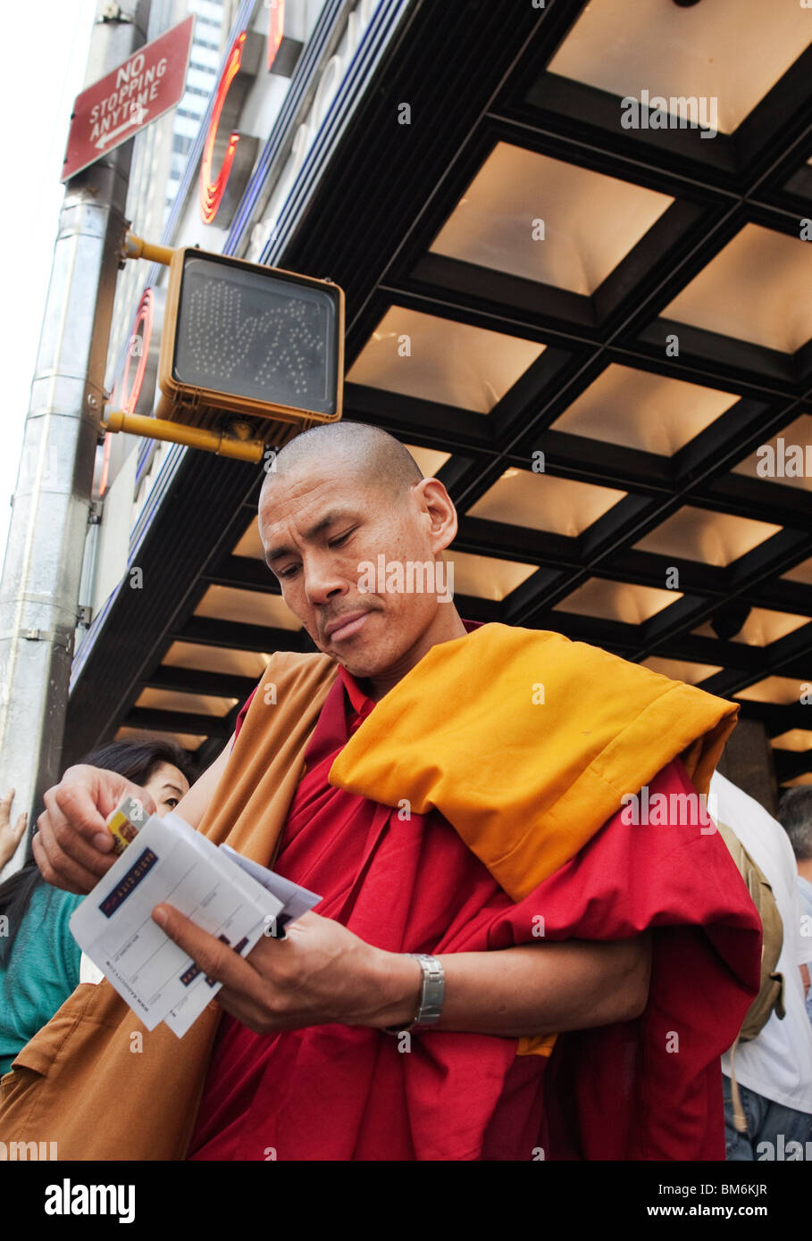 A Buddhist Monk from Tibet examines his tickets at Radio City Music Hall to listen to The XIV Dalai Lama Stock Photo