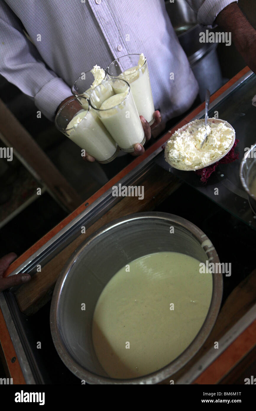 A man pours Indian lassi ( yogurt drink ) at the Sardar Market Jodhpur
