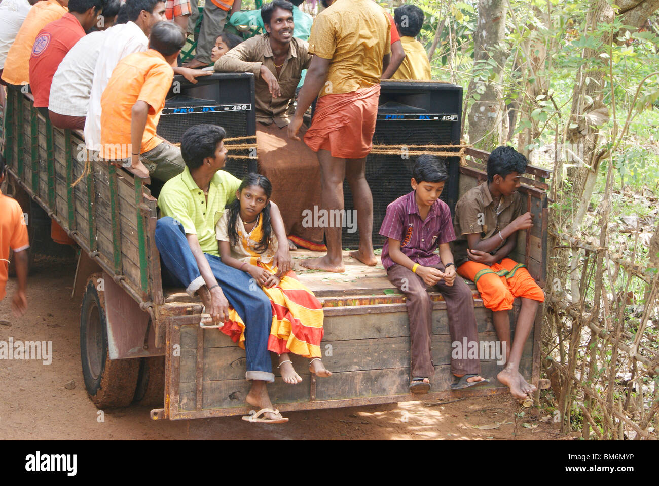 Lot of peoples traveling in a open lorry dangerously. Stock Photo