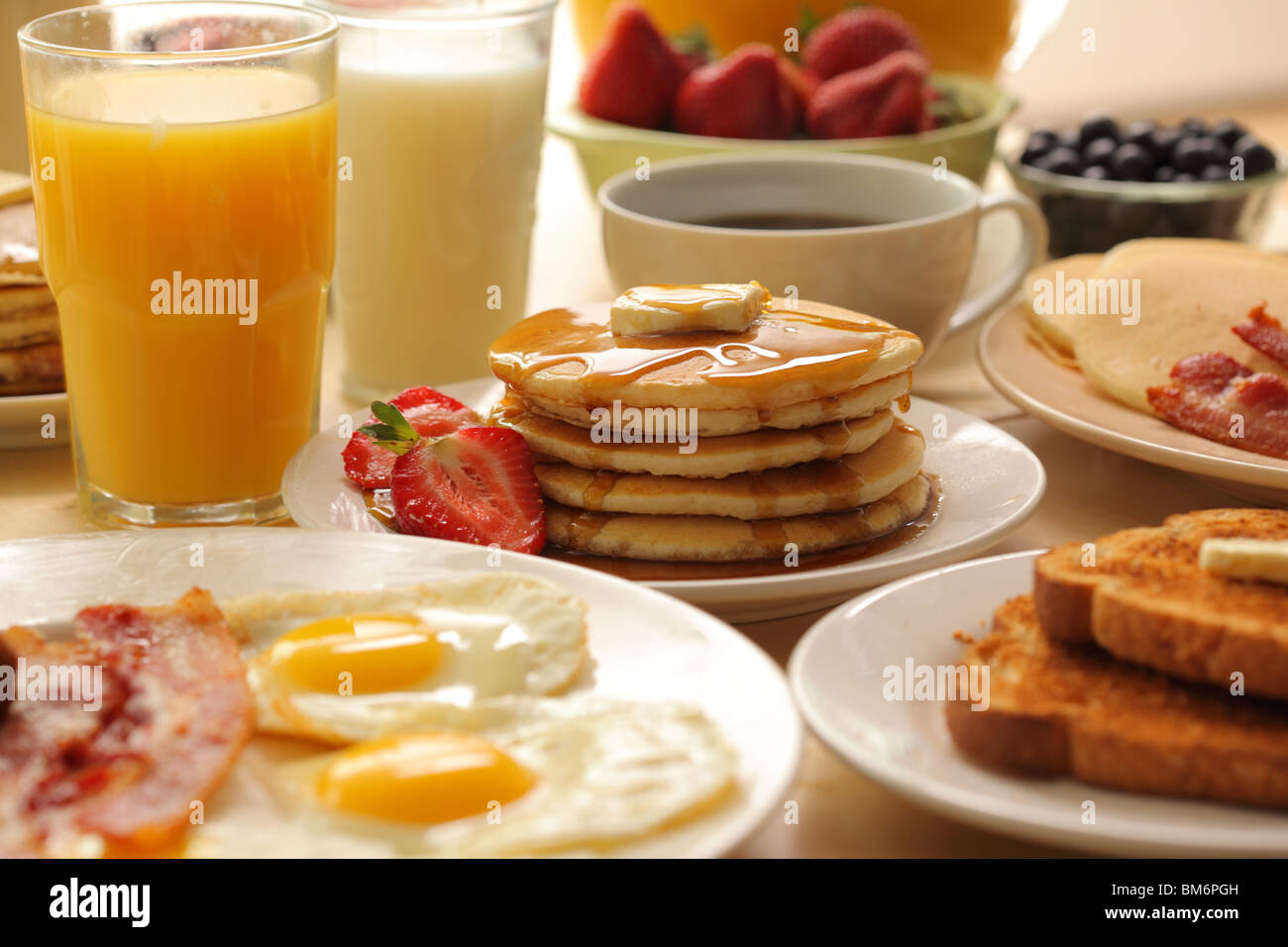 Breakfast pancakes, fruit, eggs, bacon and toast Stock Photo