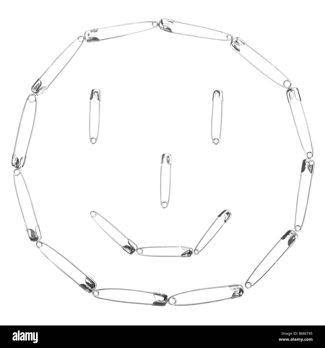 Smiley face made of safety pins Stock Photo