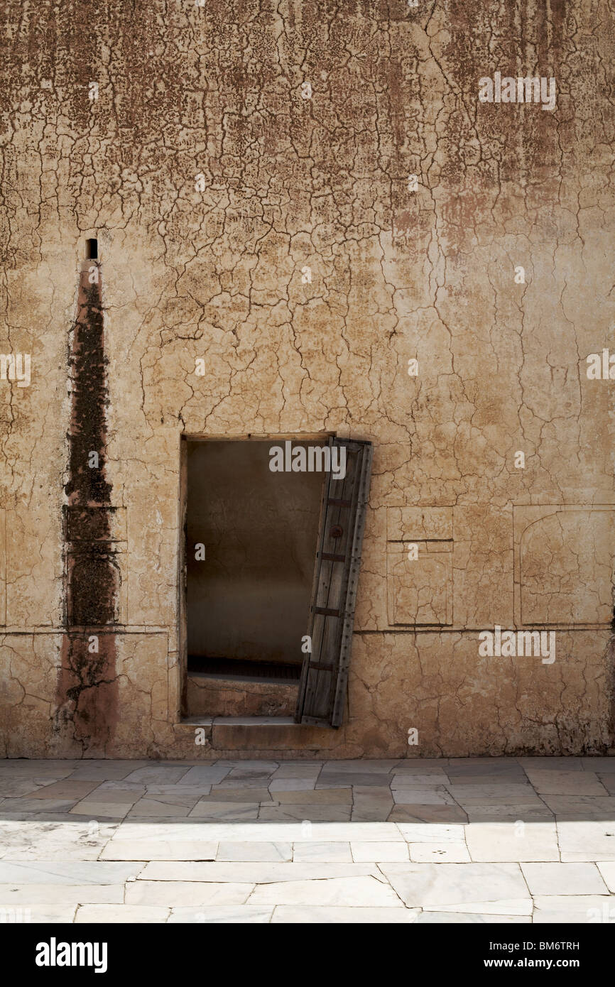 Open door in old stone wall Stock Photo