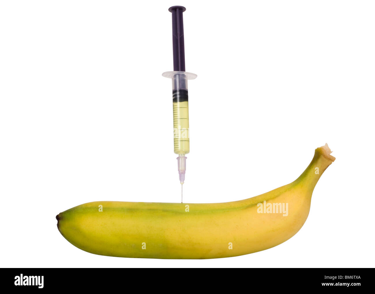 Syringe being injected into a banana Stock Photo