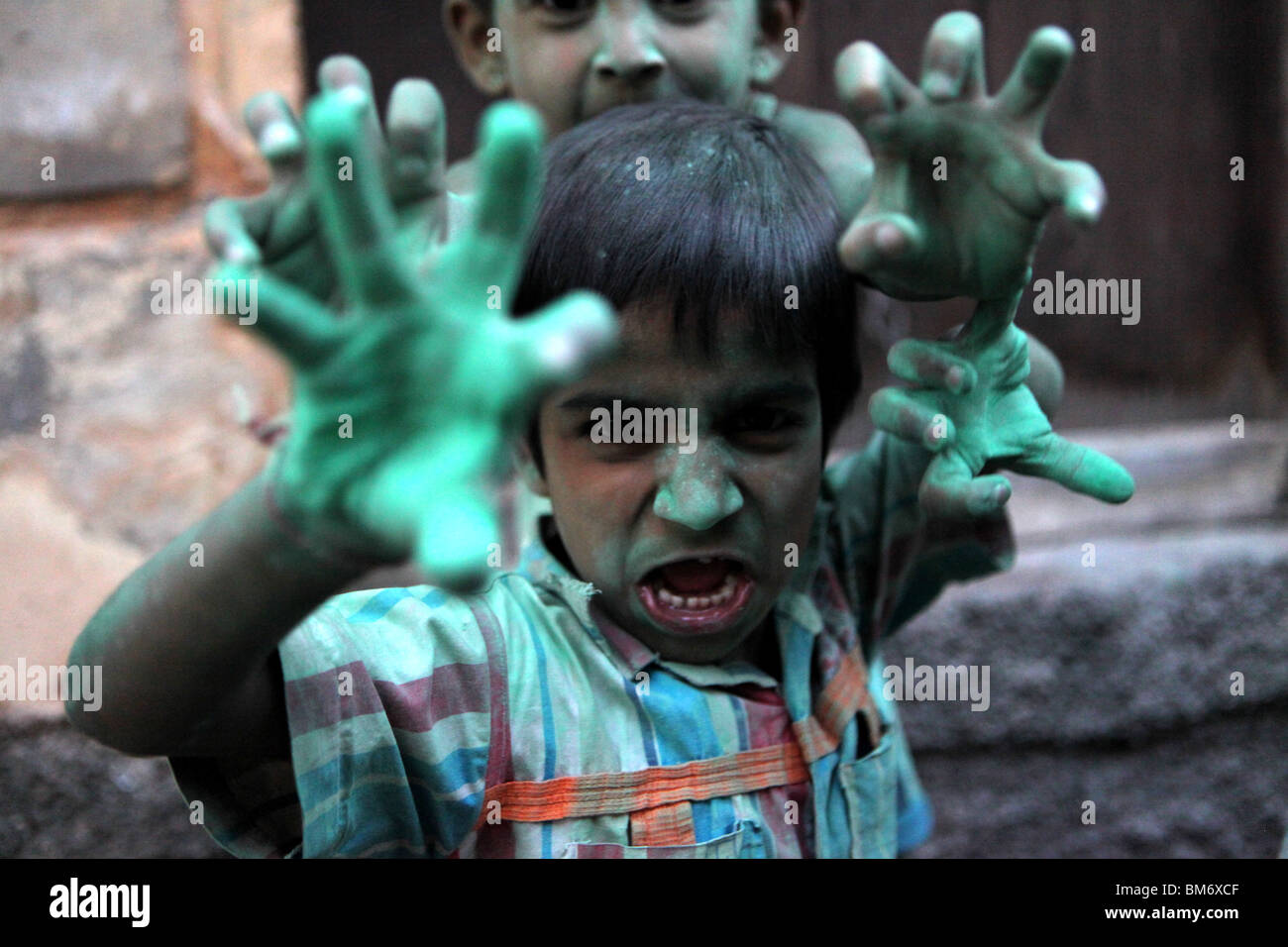 Children playing with coloured kumkum powder in Jodhpur, known as The Blue City in Rajasthan, India. Stock Photo