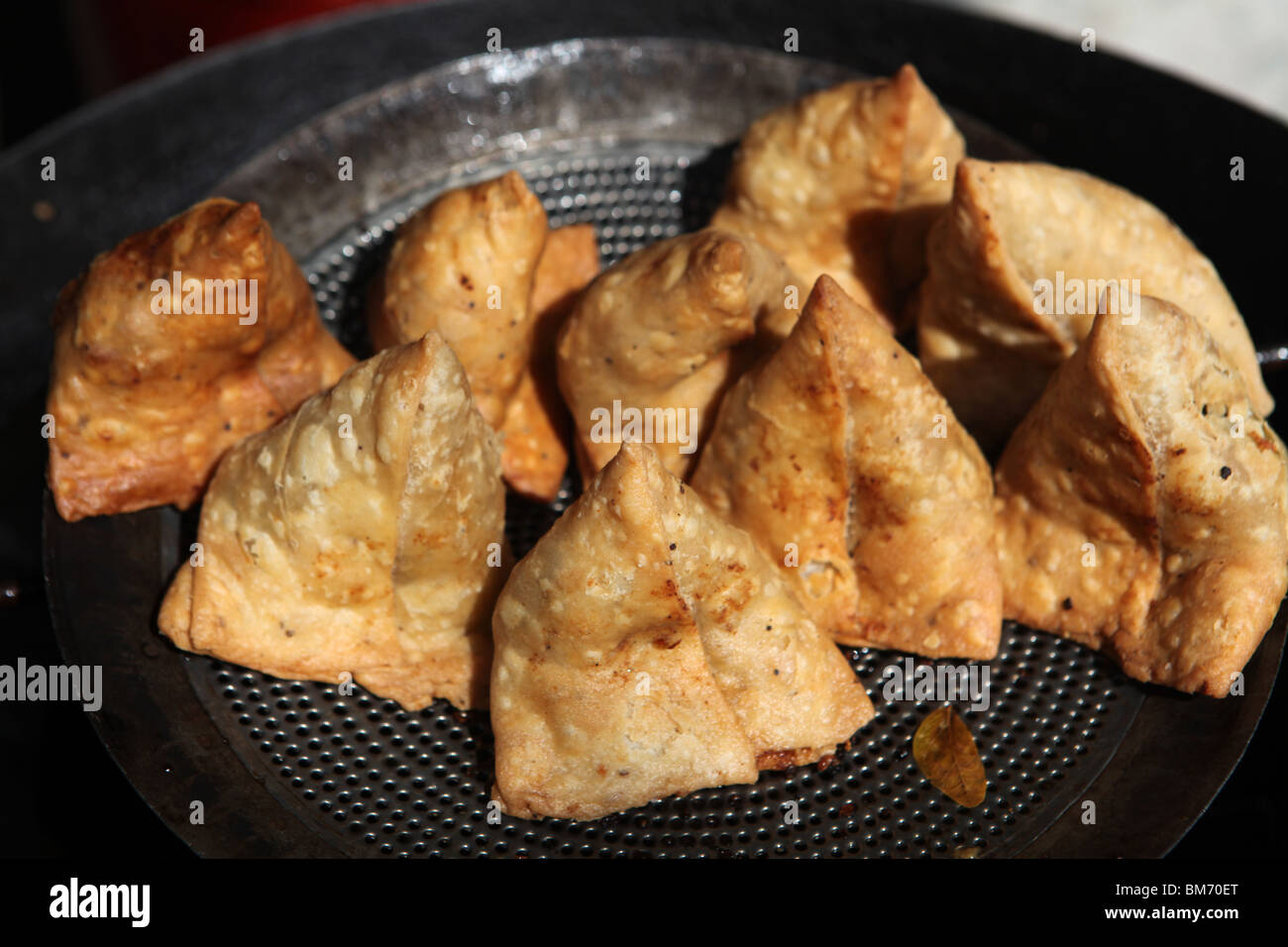 Indian Samosa ( samosas ) deep fried on the street in Udaipur