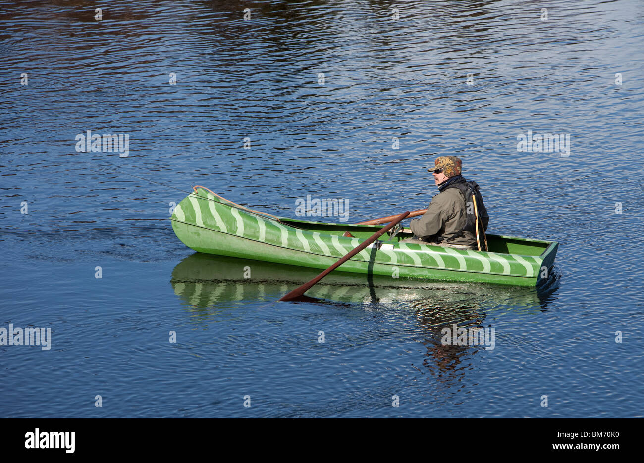 Adult male fisherman rowing a small canoe , Finland Stock Photo Alamy