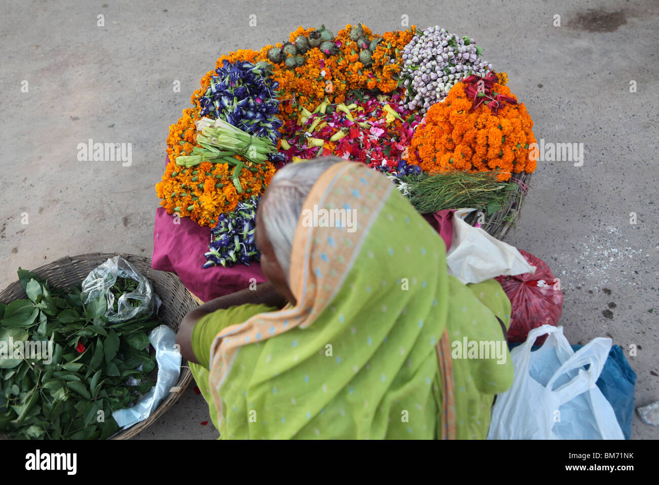 An Indian women selling flowers during Diwali in Varanasi or Benares or Banaras, Uttar Pradesh, India. Stock Photo