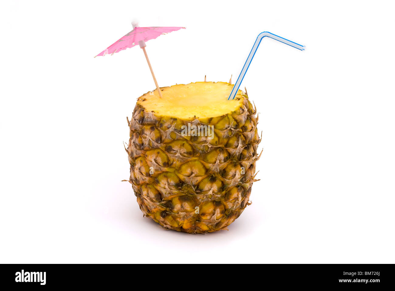 pineapple with straw and umbrella on a white background Stock Photo