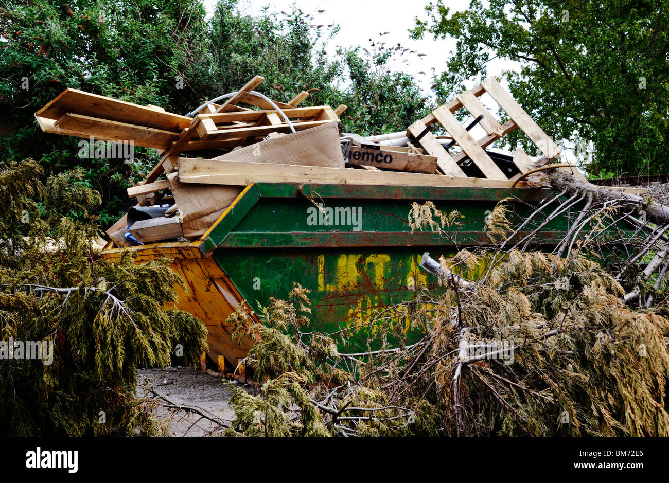 skip loaded with rubbish waiting for disposal Stock Photo