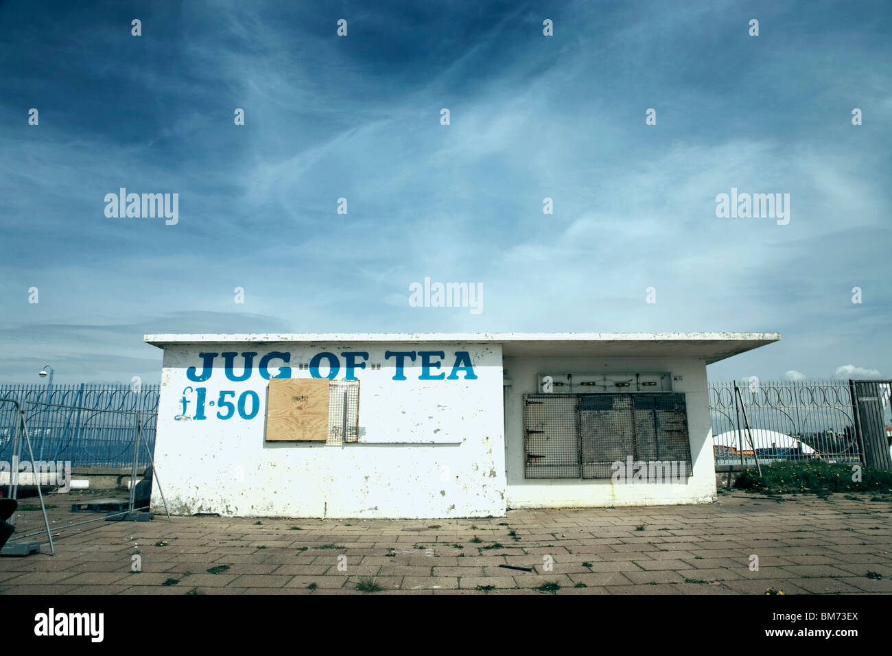 architecture image of a small closed down café building with slogan jug of tea on the front on a sunny day with blue sky Stock Photo