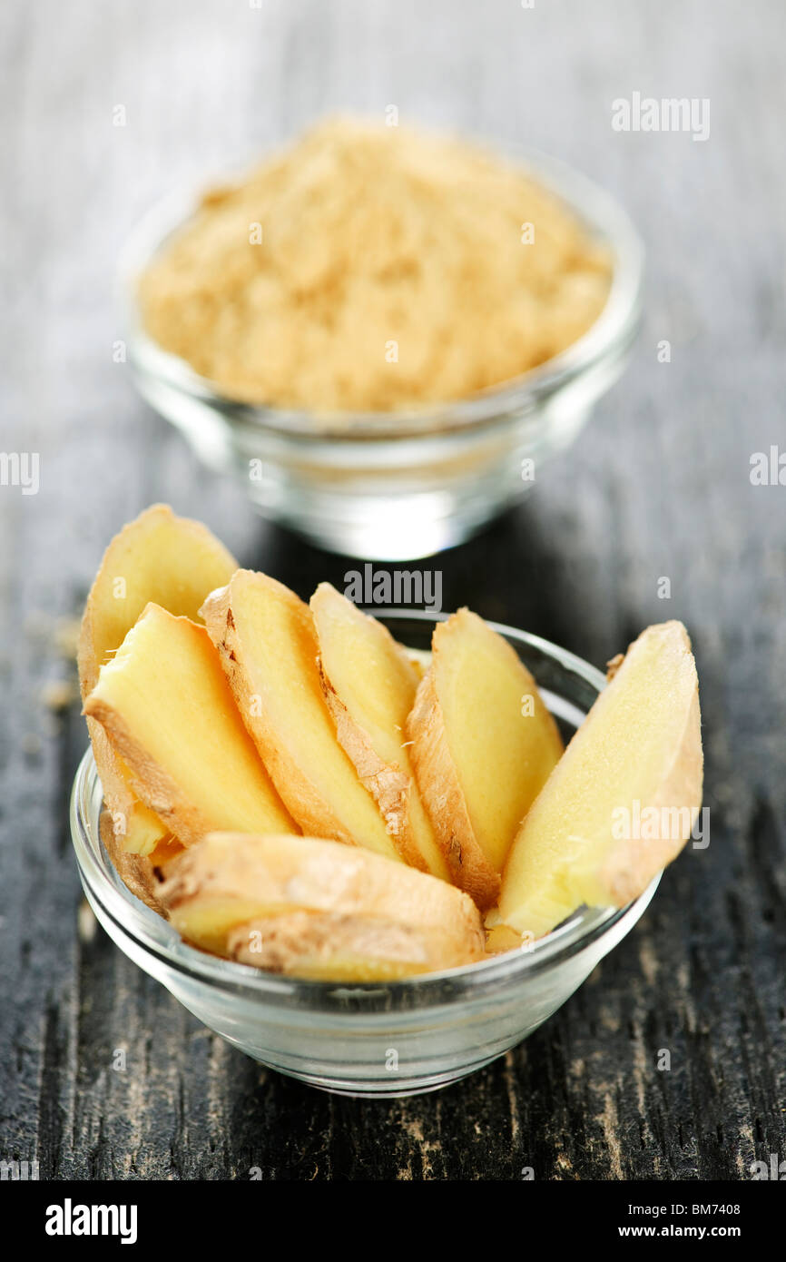 Sliced and ground fresh ginger root spice in glass bowls Stock Photo