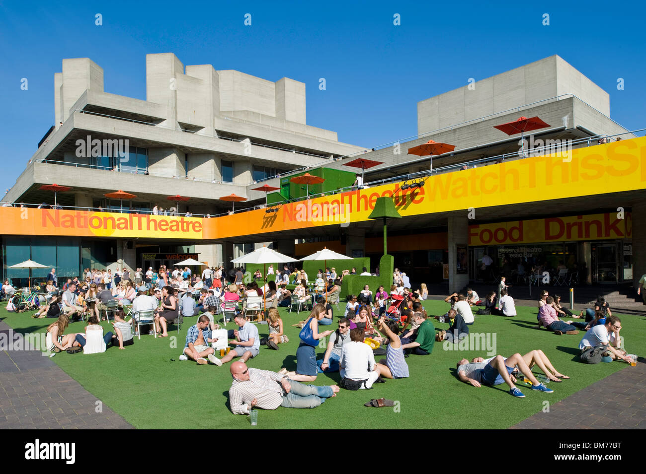 People enjoy hot summer day by Royal National Theatre, Southbank, London, United Kingdom Stock Photo