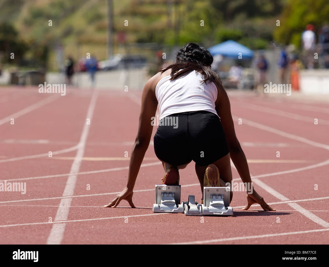 Female athlete in starting blocks hires stock photography and images
