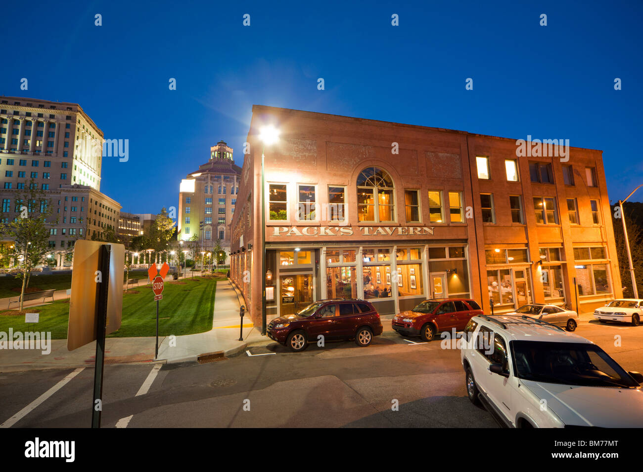 Pack's Tavern on S. South Spruce ST, downtown Asheville, NC. Court Plaza; City Hall and Court House building at dusk. Stock Photo