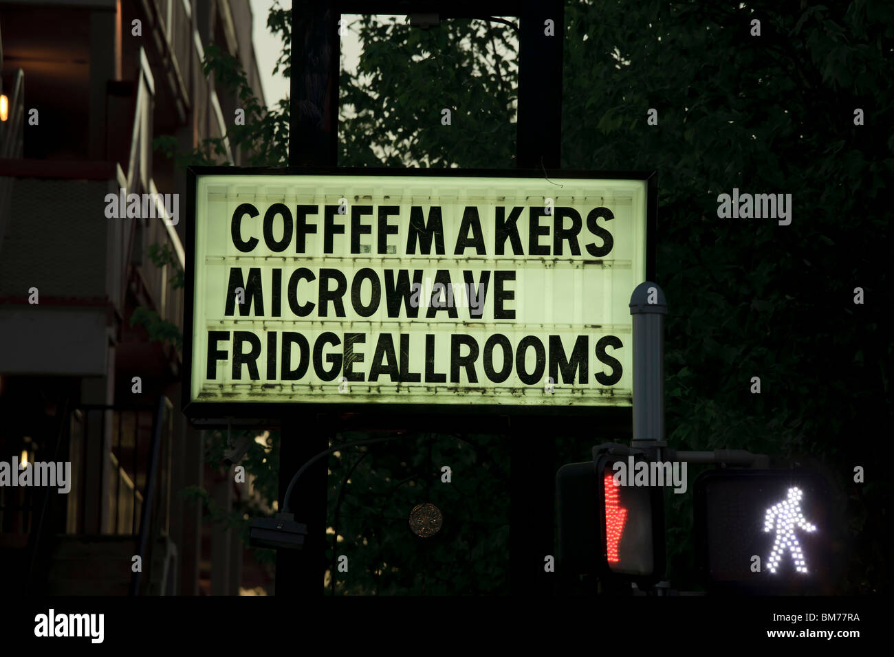 A sign saying Coffeemakers Microwave Fridge All Rooms. In front of a motel, hotel in Asheville NC. Stock Photo