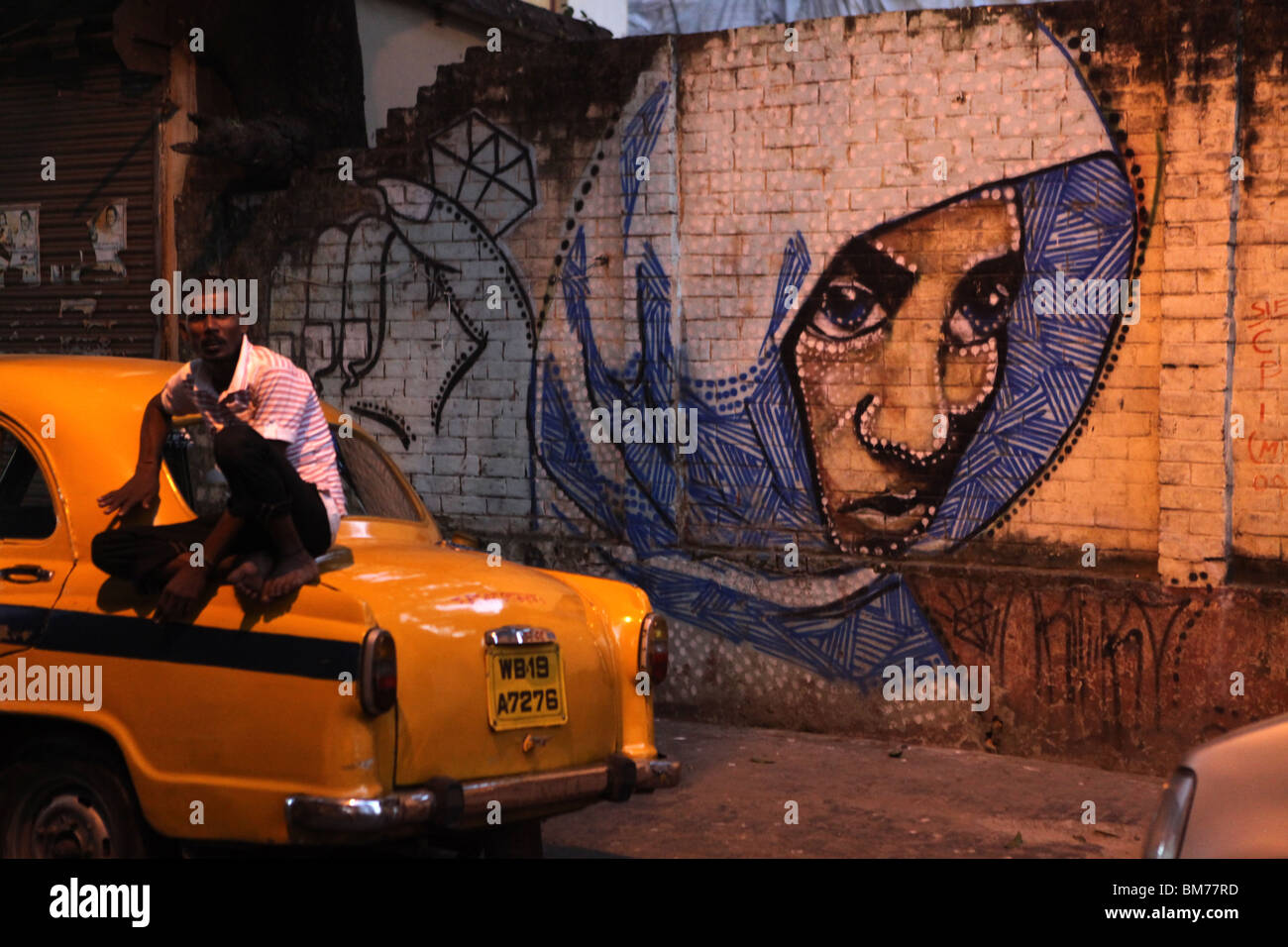A man resting on his taxi in Kolkata, formerly called Calcutta in West Bengal, India. Stock Photo