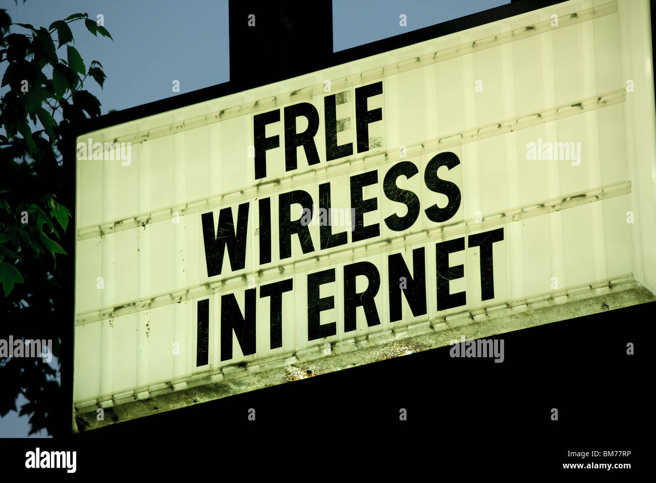 A sign saying Wirless Internet instead of Wireless. In front of a motel, hotel in Asheville NC. Stock Photo