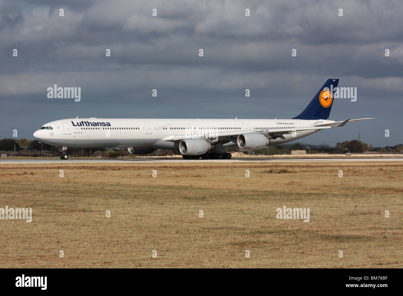 Lufthansa Airbus A340-600 long-haul widebody passenger jet plane lining up on the runway for departure from Malta Stock Photo