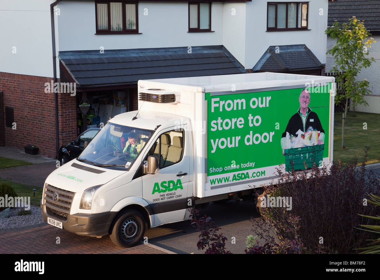 UK, Britain. Asda home delivery van outside a house delivering online