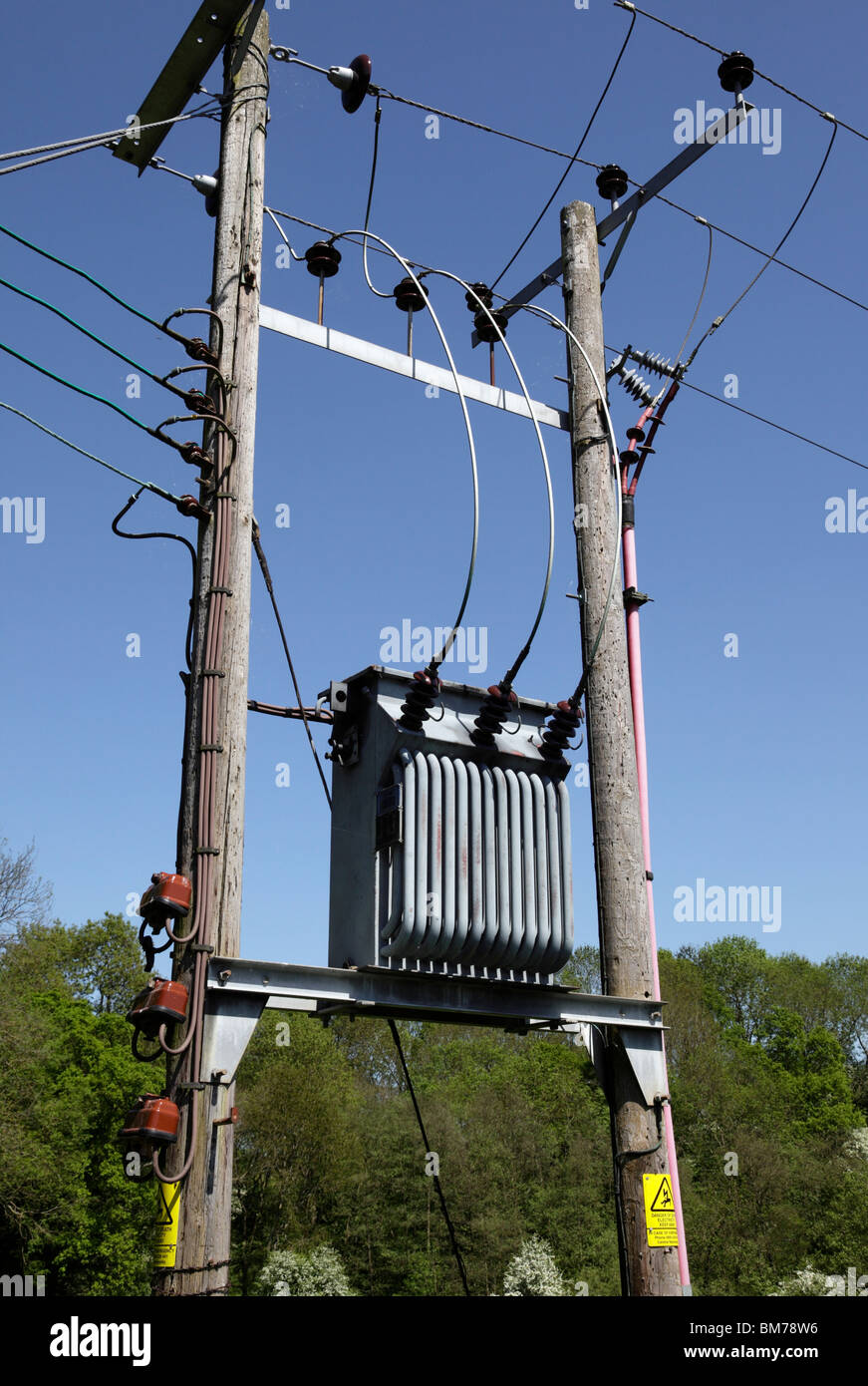 3 Phase electricity transformer mounted between 2 utility poles Upper Arley Village Worcestershire UK Stock Photo