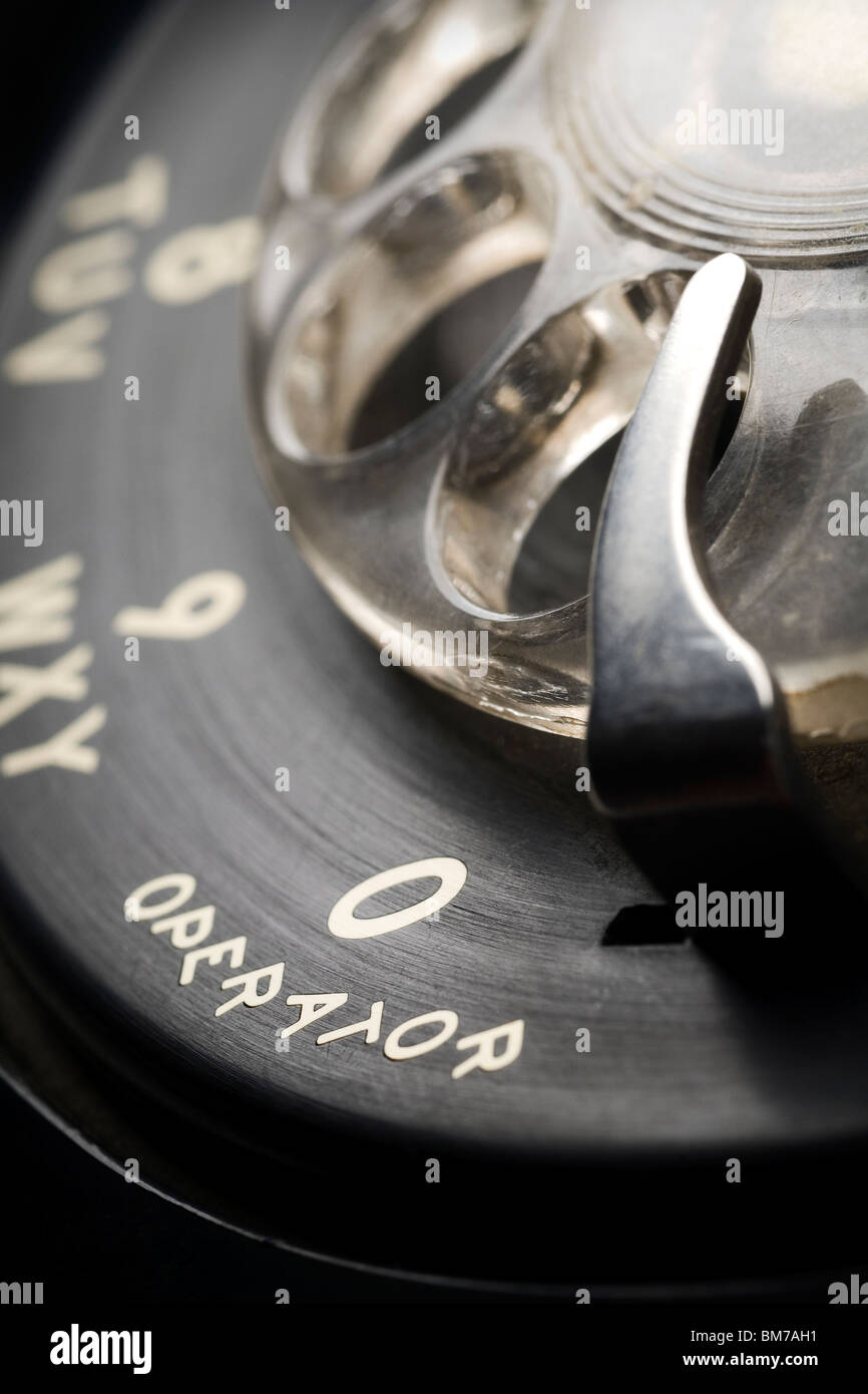 a detail of an old-fashioned rotary phone dial with shallow depth of field and focus on 0 for an operator Stock Photo