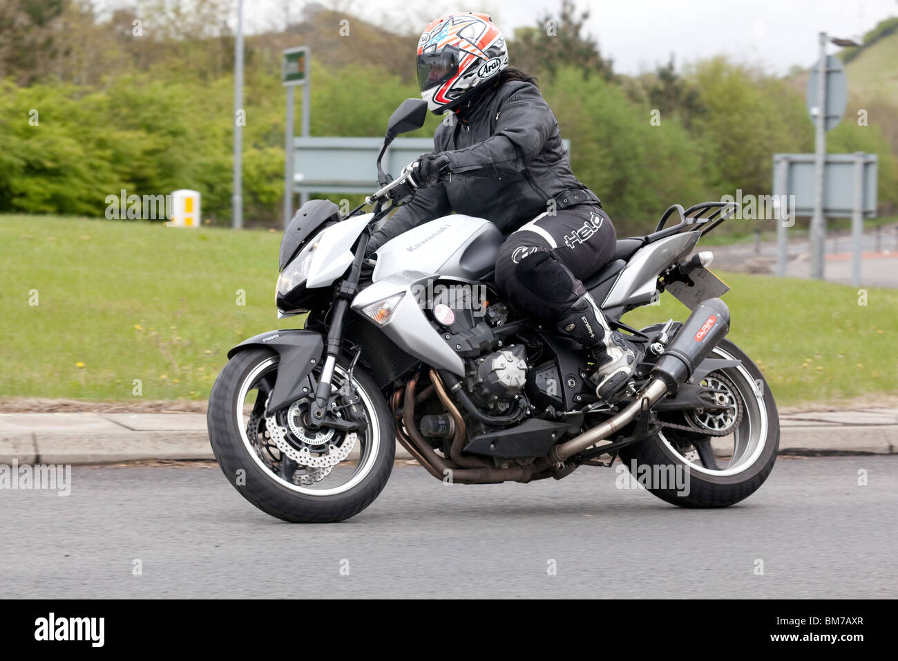 Traffic motorbike motorcyclist on a roundabout UK Stock Photo