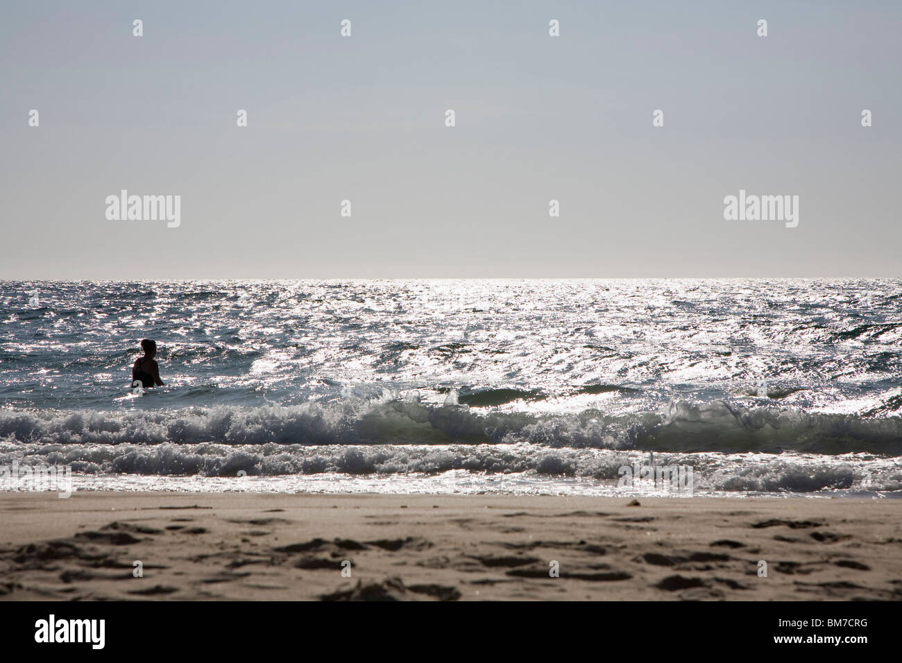 Silhouette of a man standing in the sea Stock Photo - Alamy